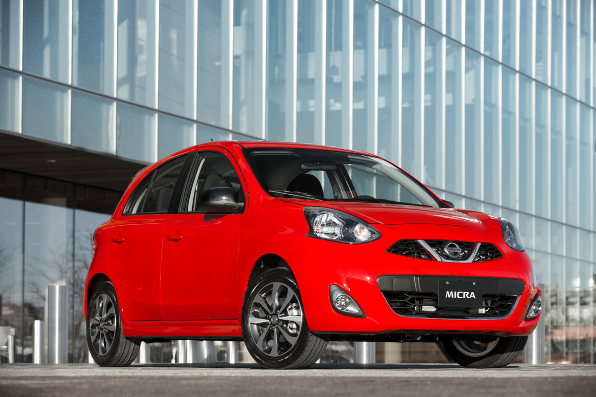 Red pre-owned Nissan Micra parked outside