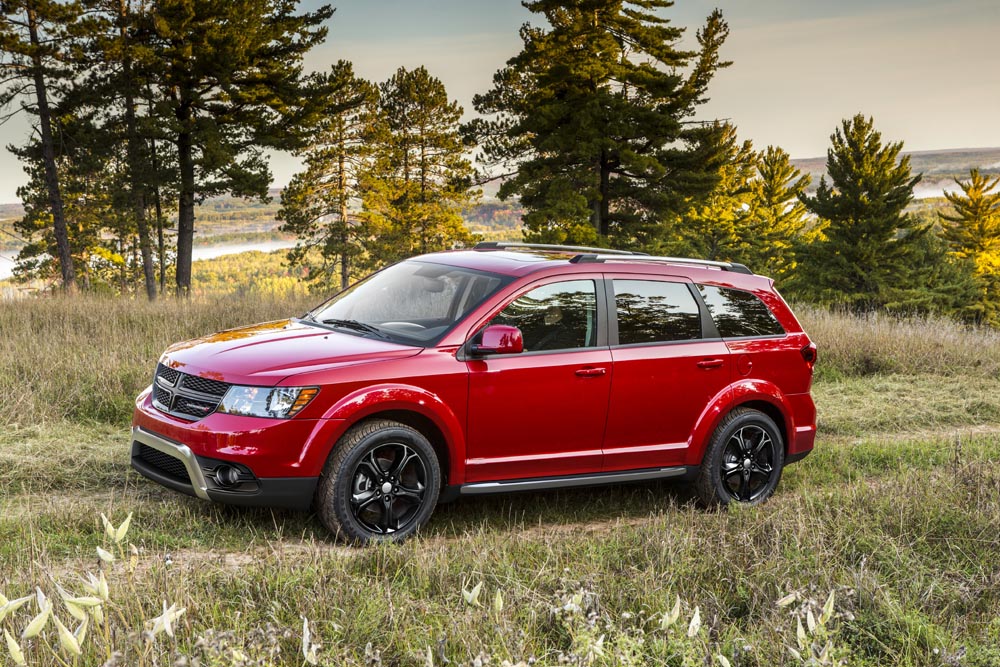 Side view of red Dodge Journey in Canadian outdoors